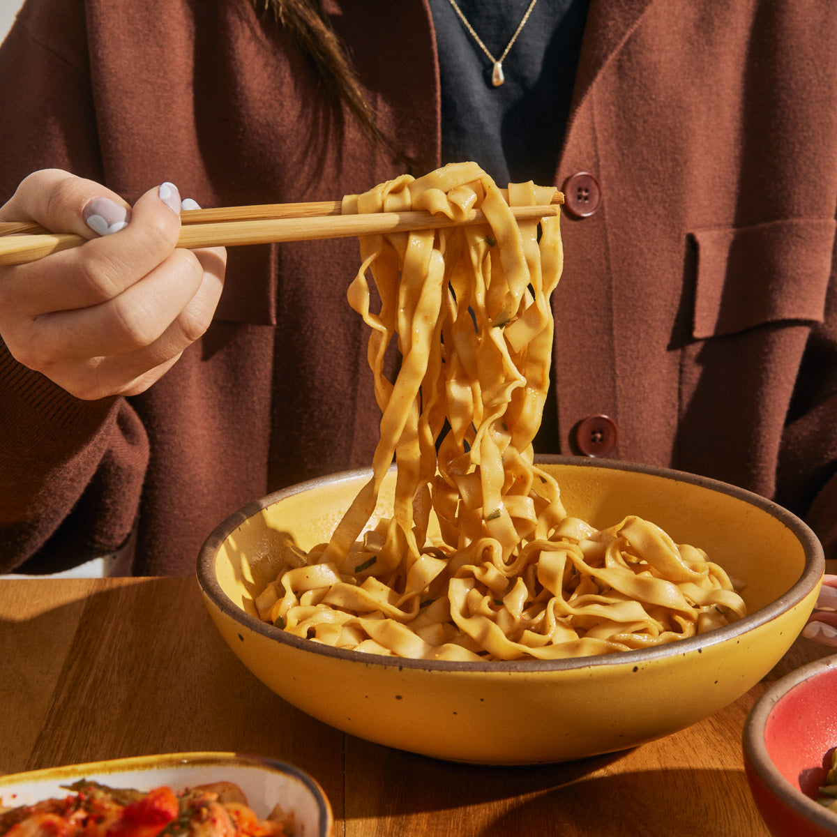 noodles being pulled with chopsticks