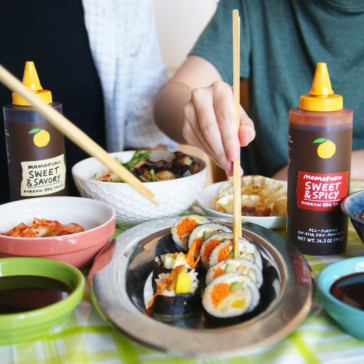 A bottle of Sweet & Spicy BBQ Sauce and sushi