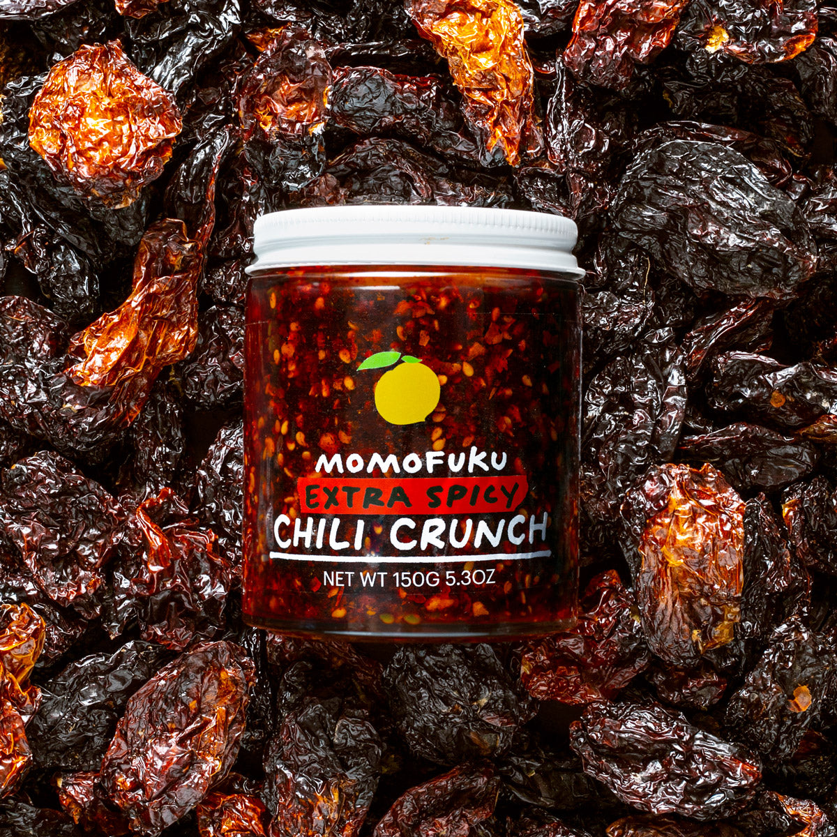 extra spicy chili crunch jar on a bed of peppers