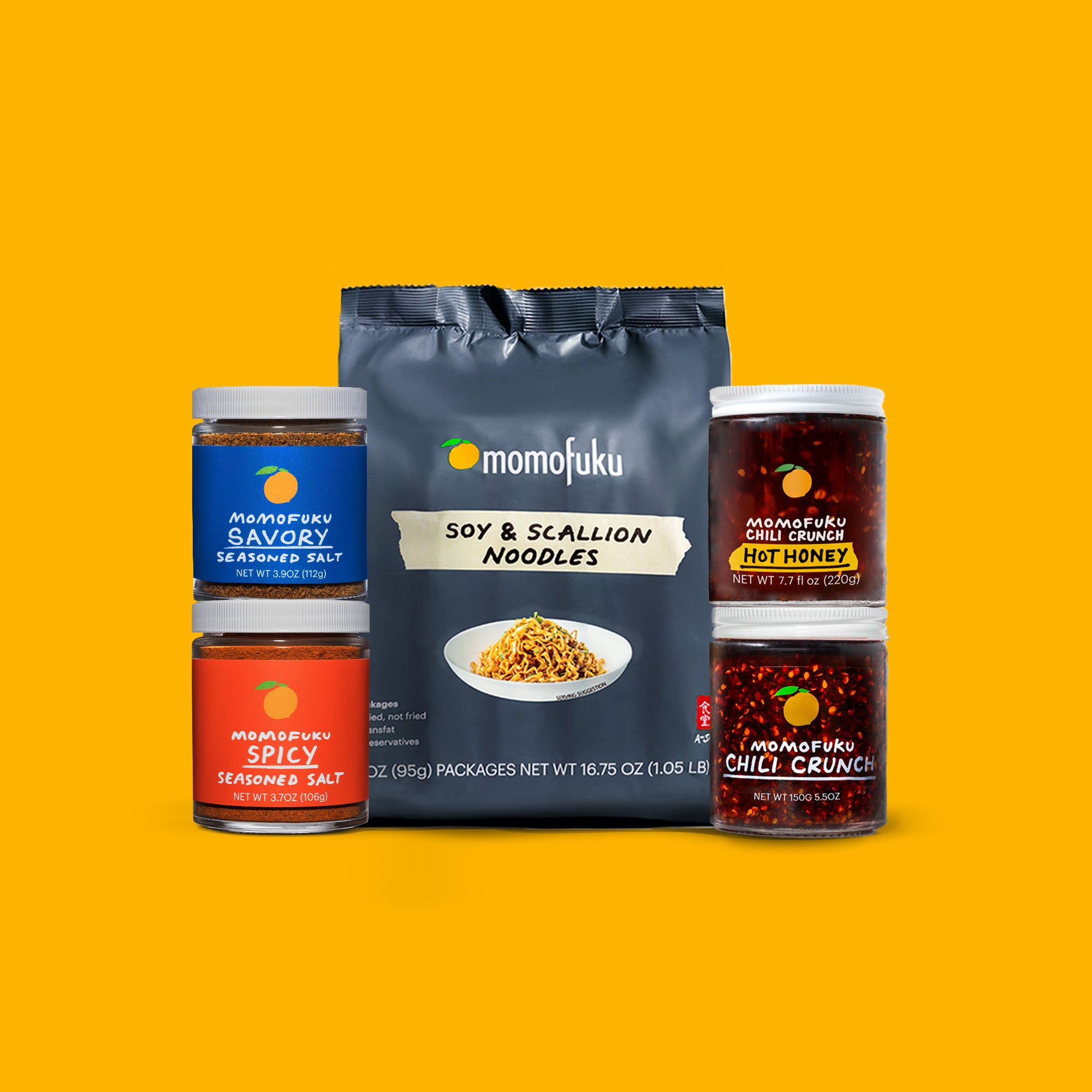 A pack of Soy & Scallion Noodles, a jar of Savory Salt, a jar of Spicy Salt, a jar of Hot Honey Chili Crunch and a jar of Chili Crunch