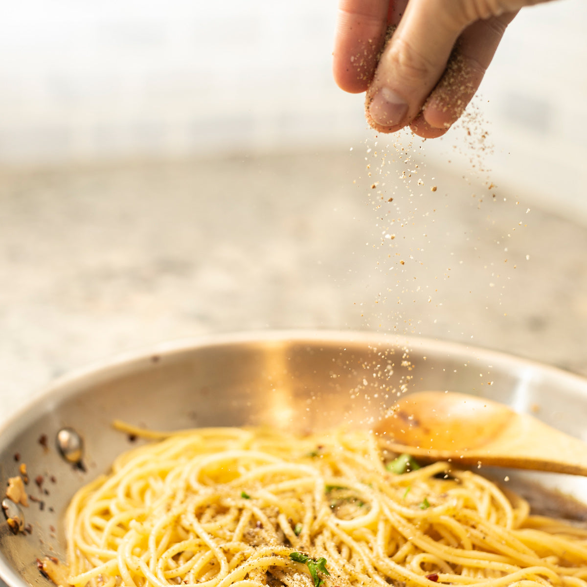 savory salt sprinkled onto pasta